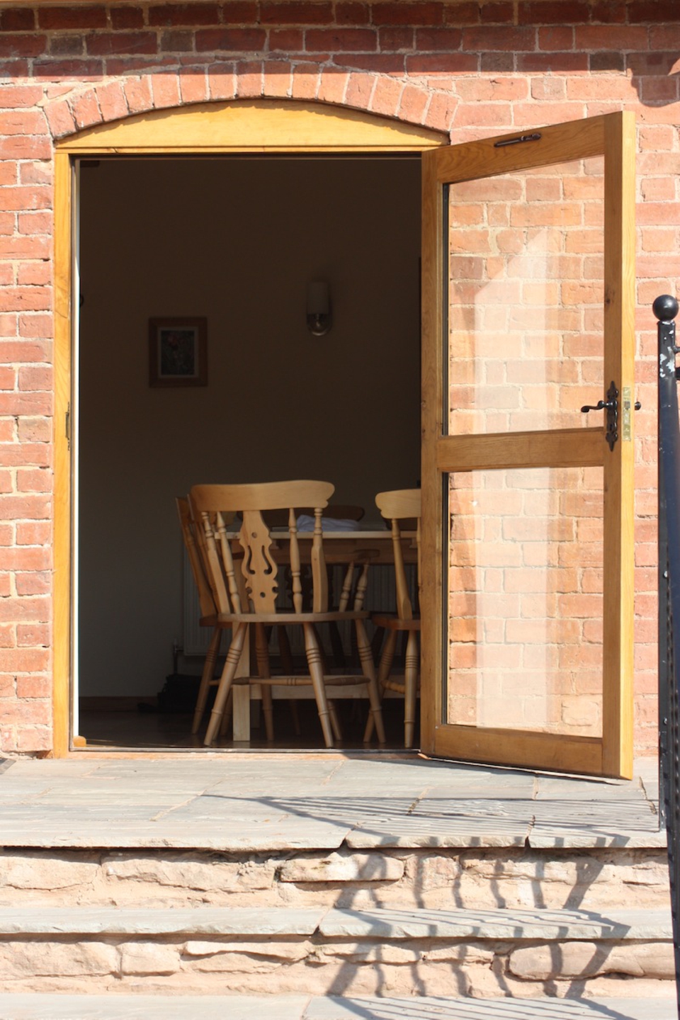 The lounge/dining room door leads straight out onto a sunny patio